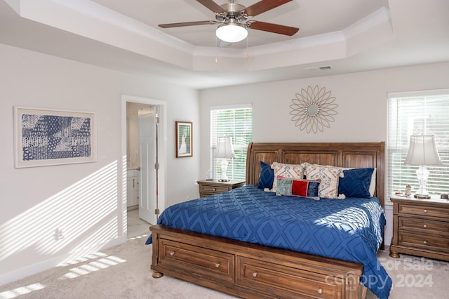 bedroom with a tray ceiling, ceiling fan, and light colored carpet