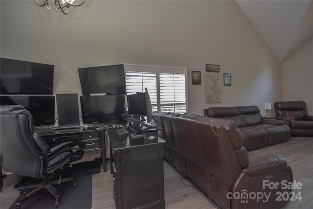 living room with light wood-type flooring and high vaulted ceiling