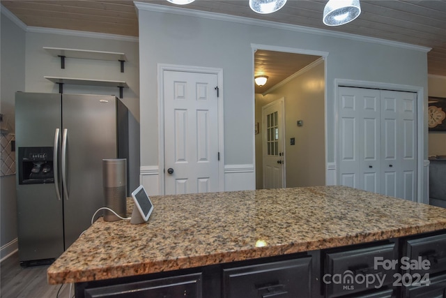 kitchen with dark hardwood / wood-style floors, light stone counters, stainless steel fridge with ice dispenser, and ornamental molding