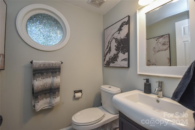 bathroom with vanity and toilet