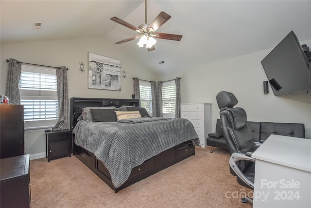 carpeted bedroom featuring multiple windows, ceiling fan, and vaulted ceiling