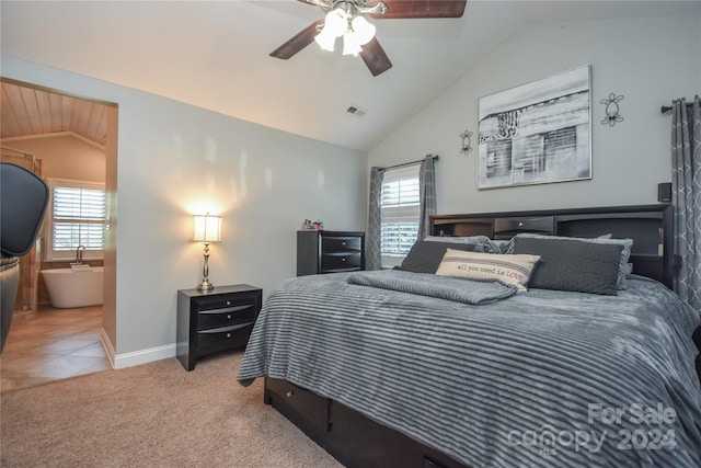 bedroom featuring light carpet, vaulted ceiling, multiple windows, and ceiling fan