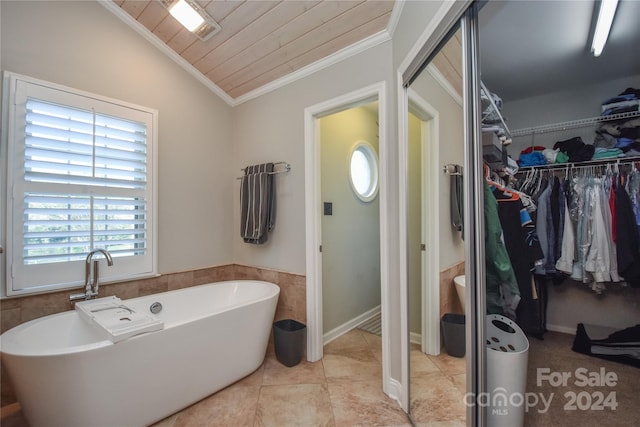 bathroom with wood ceiling, lofted ceiling, a bath, and a wealth of natural light