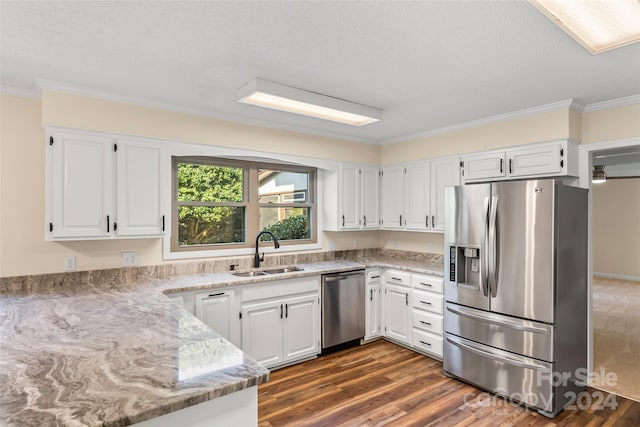 kitchen featuring white cabinets, stainless steel appliances, and sink