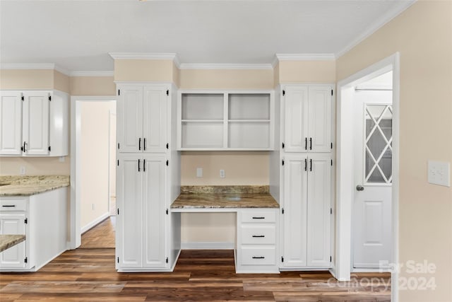 kitchen featuring dark wood-type flooring, light stone countertops, ornamental molding, and white cabinetry