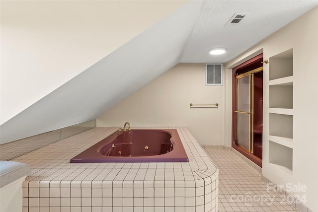 bathroom with separate shower and tub, lofted ceiling, built in features, a textured ceiling, and tile patterned floors