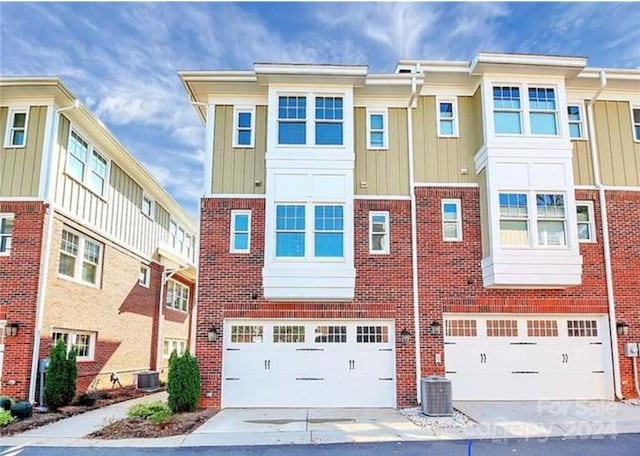 view of front of home with a garage and cooling unit