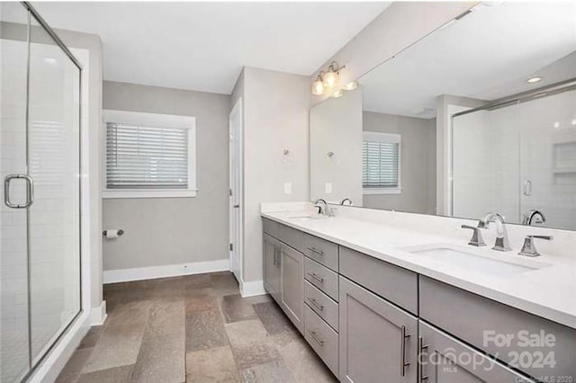 bathroom featuring vanity and an enclosed shower