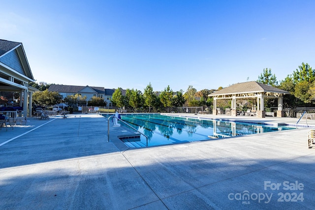 view of swimming pool featuring a gazebo and a patio area