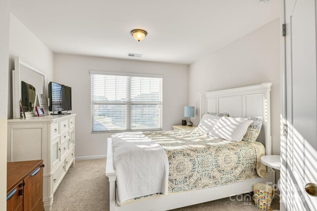 bedroom featuring light carpet