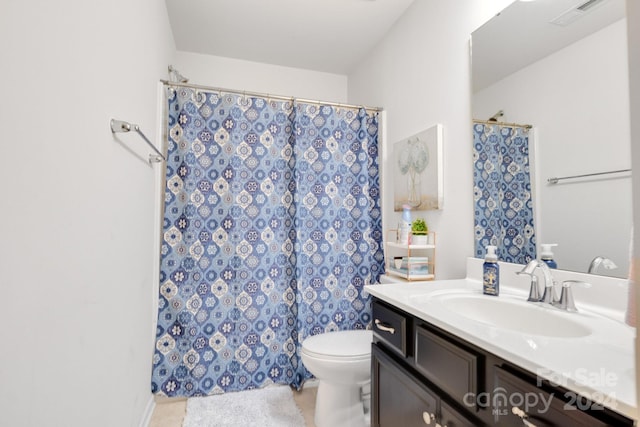 bathroom with vanity, a shower with curtain, toilet, and tile patterned floors