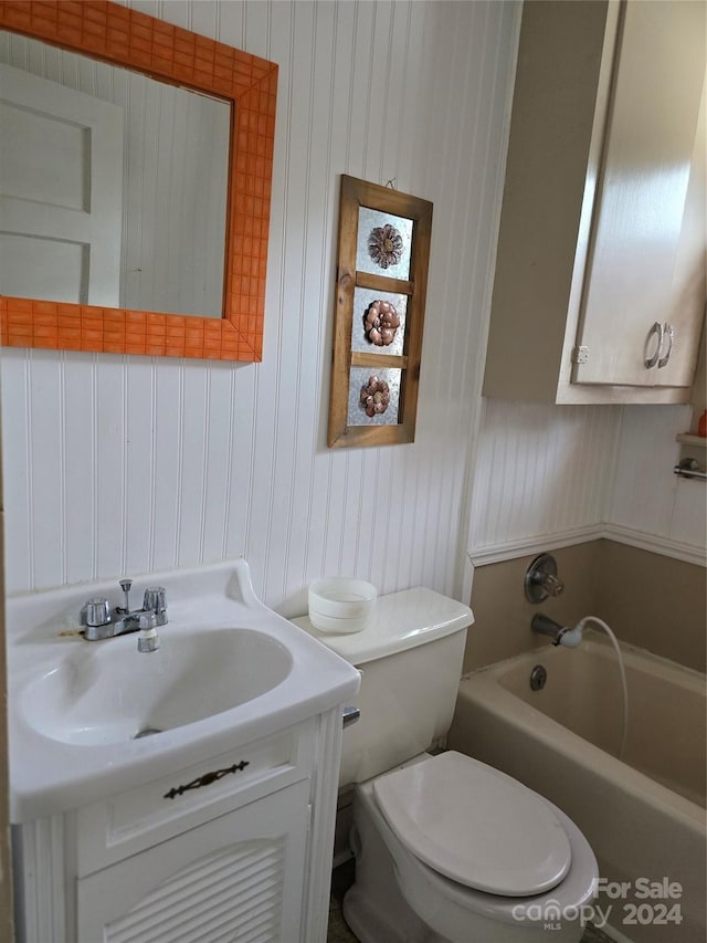 bathroom with a bathing tub, toilet, and vanity