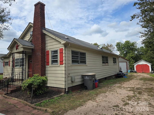 view of home's exterior featuring a shed