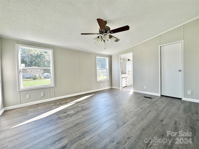 spare room with wood-type flooring, a textured ceiling, and ceiling fan