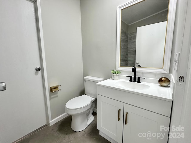 bathroom featuring vanity, toilet, and tile patterned floors