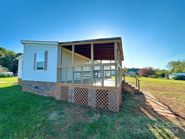 exterior space with a wooden deck and a yard