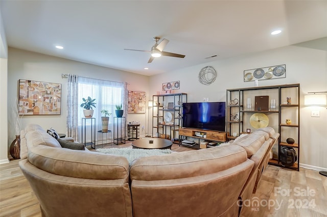 living room featuring light hardwood / wood-style floors and ceiling fan