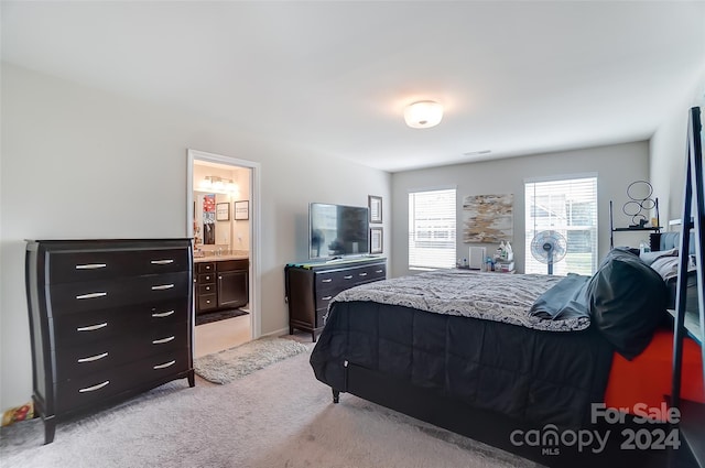 carpeted bedroom with ensuite bath