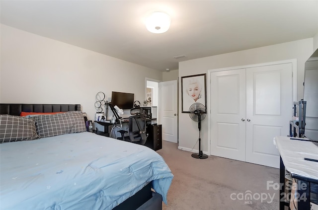 carpeted bedroom with a closet