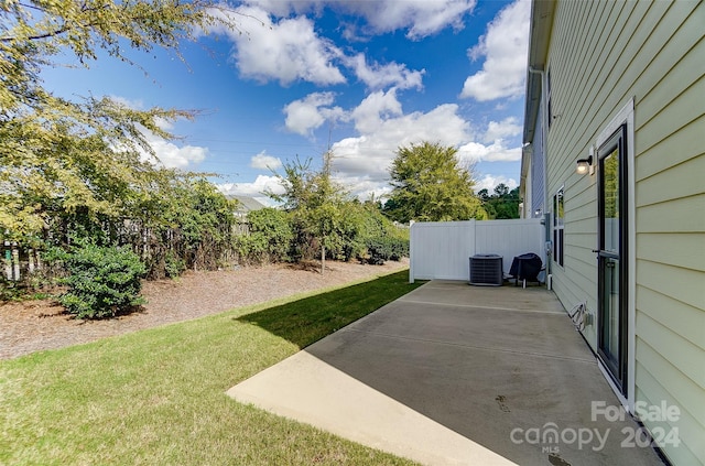 view of yard with central AC and a patio area