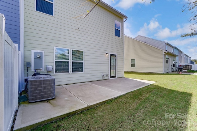 back of house with a patio, a lawn, and central AC unit