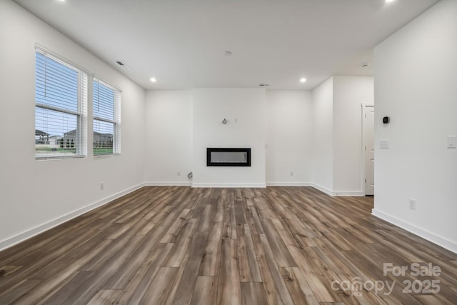 unfurnished living room featuring dark hardwood / wood-style flooring