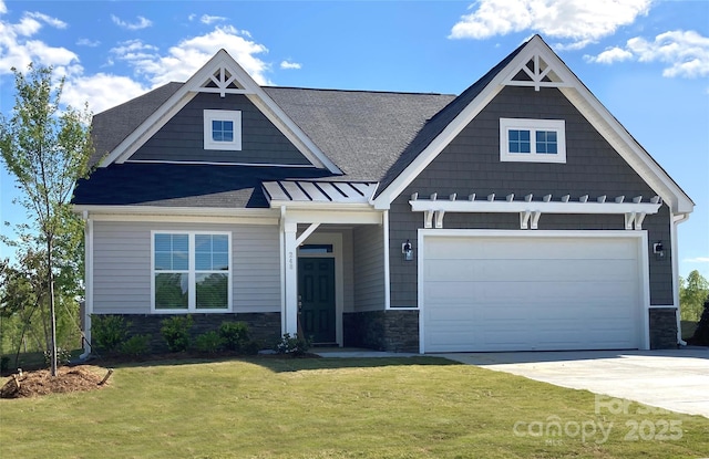 craftsman house with a front lawn and a garage