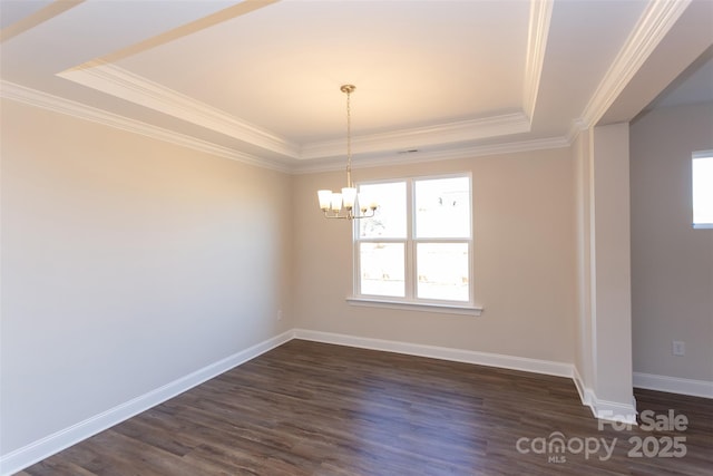 unfurnished dining area with dark hardwood / wood-style floors, a chandelier, ornamental molding, and a raised ceiling