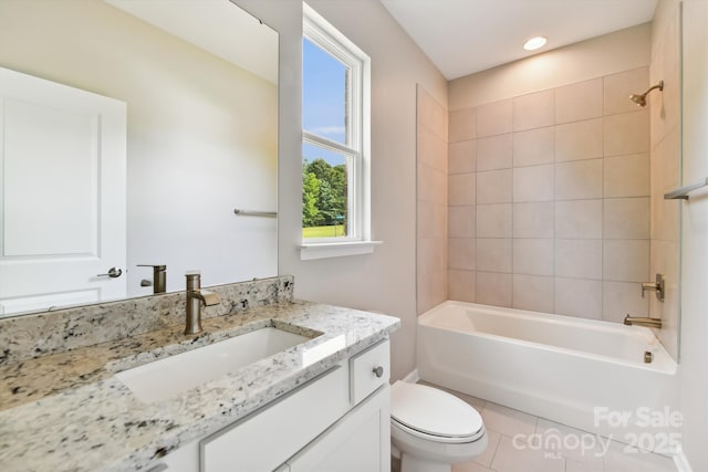 full bathroom with toilet, tiled shower / bath, vanity, and tile patterned floors