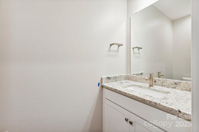 bathroom with toilet and vanity