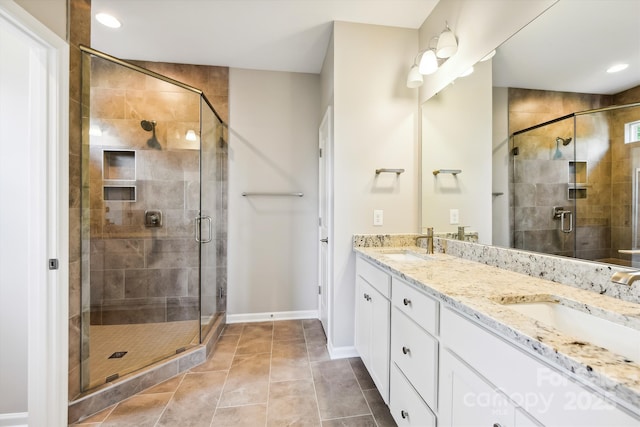 bathroom featuring a shower with shower door, vanity, and tile patterned floors