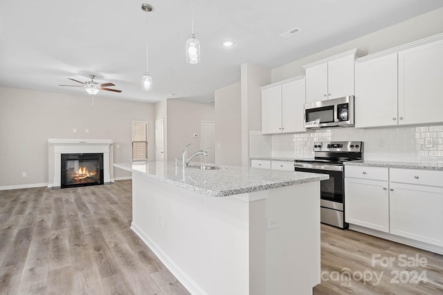 kitchen with white cabinetry, a center island with sink, appliances with stainless steel finishes, and sink