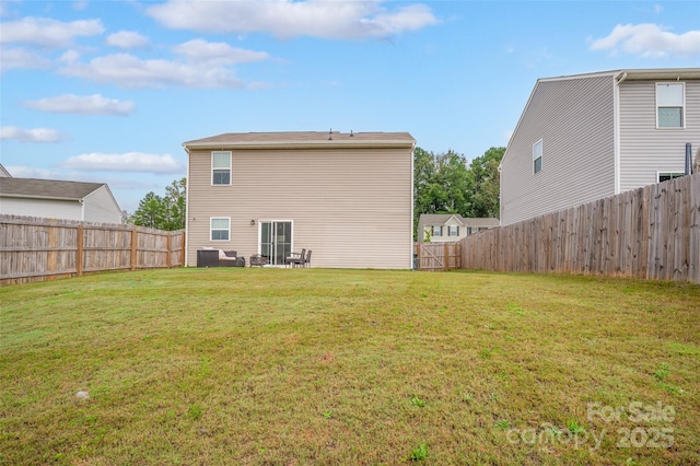 back of house with outdoor lounge area and a lawn