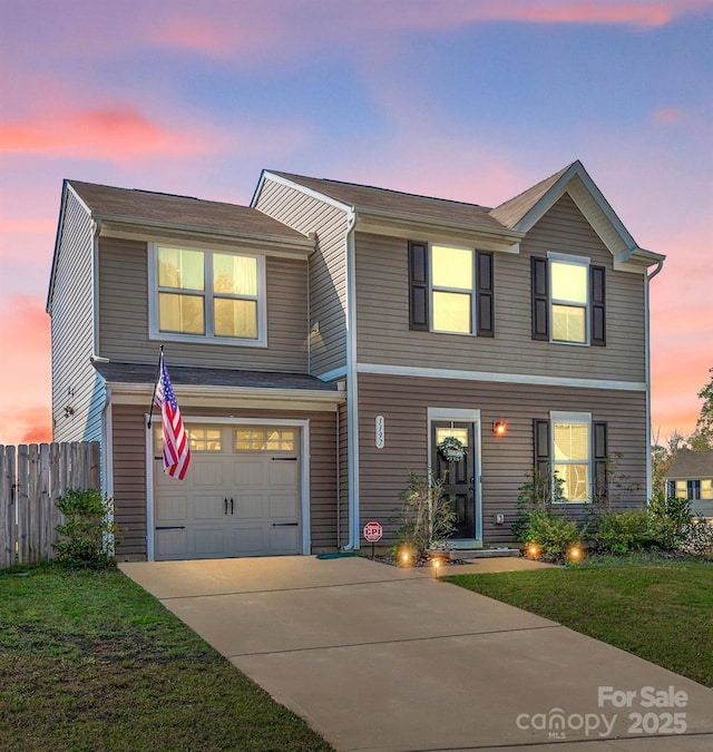 view of front of home with a lawn and a garage