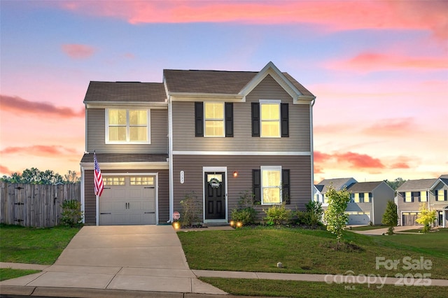 view of front of home featuring a lawn and a garage