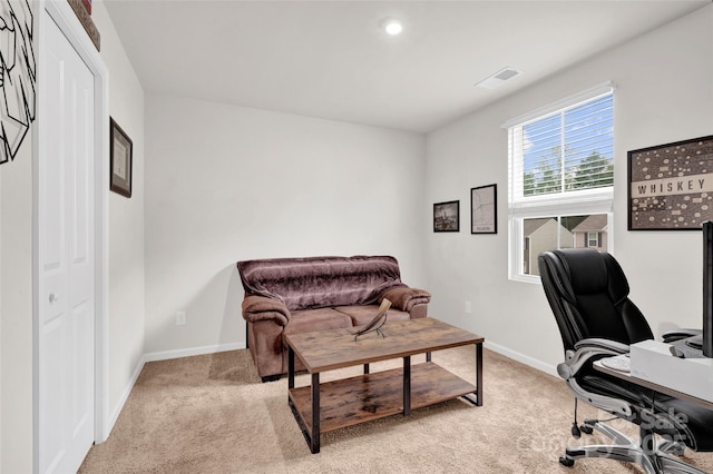 office featuring light carpet, visible vents, and baseboards