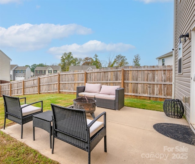 view of patio / terrace with a residential view, an outdoor living space with a fire pit, and a fenced backyard