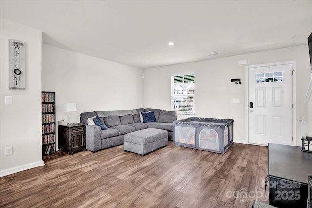 living room featuring baseboards and wood finished floors