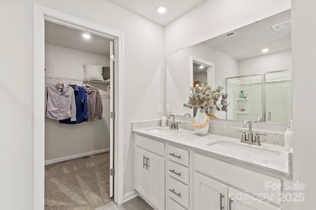 bathroom featuring vanity and a shower with shower door