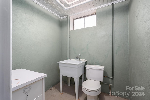 bathroom featuring ornamental molding and toilet