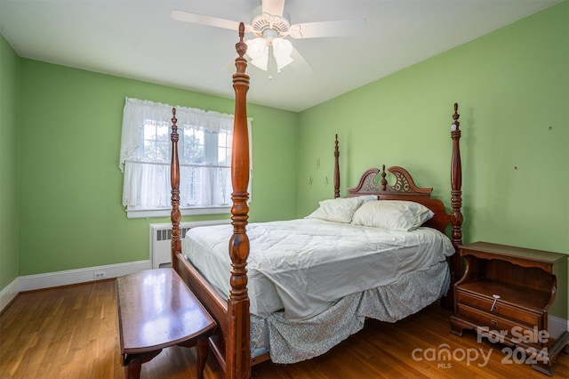 bedroom featuring radiator heating unit, wood-type flooring, and ceiling fan