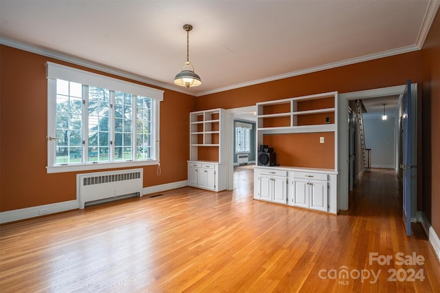 unfurnished living room with radiator, light hardwood / wood-style floors, and ornamental molding