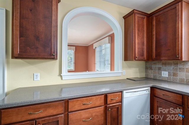 kitchen with decorative backsplash, white dishwasher, and crown molding