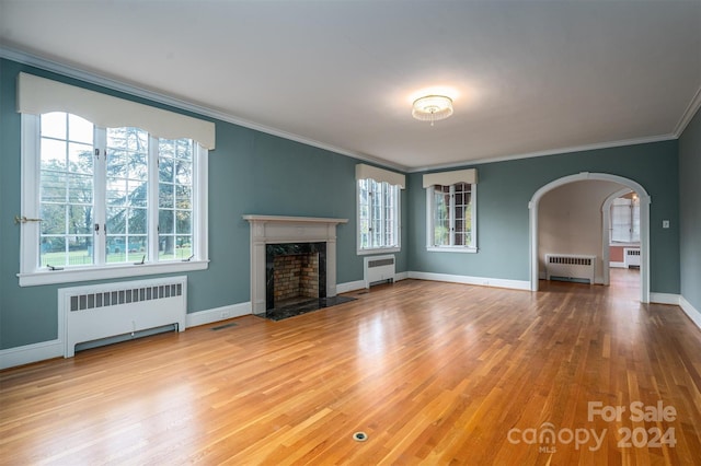 unfurnished living room with a healthy amount of sunlight and radiator