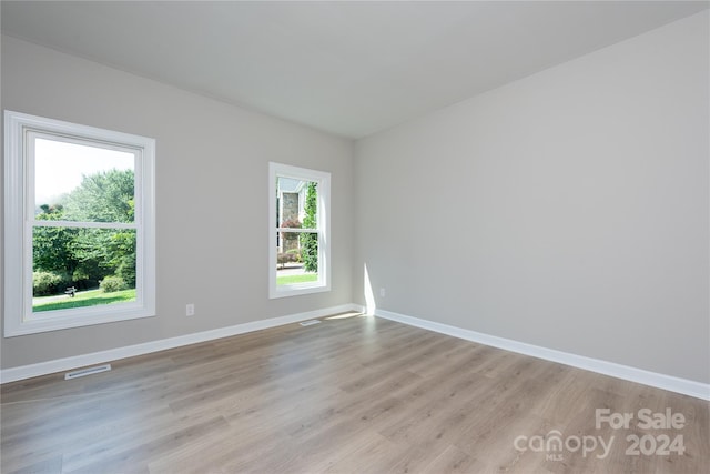 unfurnished room featuring light hardwood / wood-style floors