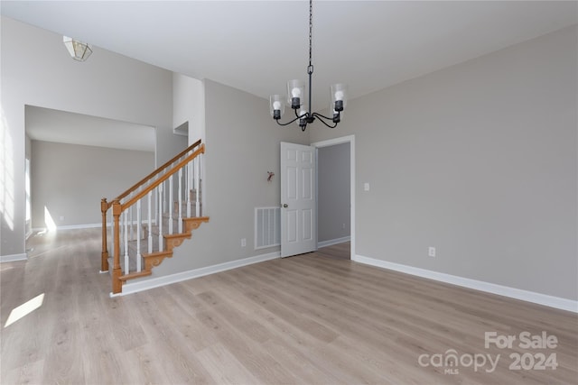 interior space with an inviting chandelier and light hardwood / wood-style floors