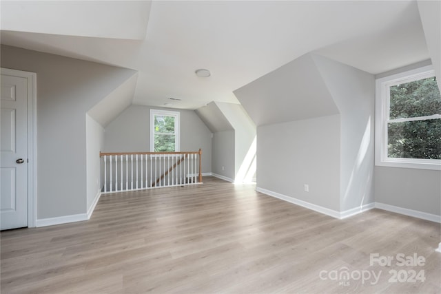 bonus room featuring light hardwood / wood-style floors and vaulted ceiling