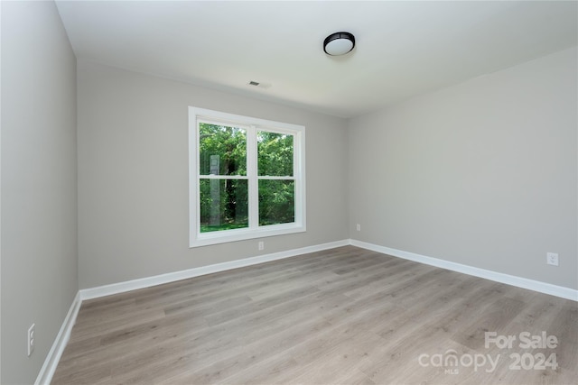 unfurnished room featuring light hardwood / wood-style floors