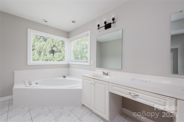 bathroom featuring vanity, tiled bath, and tile patterned floors