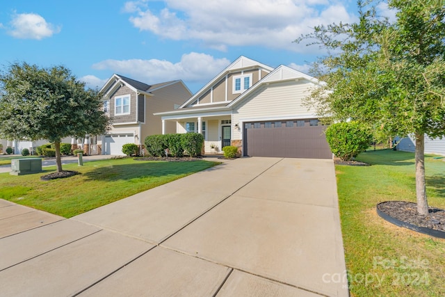 craftsman-style house with a front yard and a garage